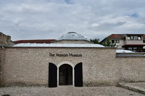 Mostar’da hamam müzesine dönüştürülmüş Osmanlı hamamının taş avlu duvarı ve arkadaki kubbe